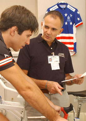 Sports Performance Program physician 
      Massimo Testa consults with cyclist Brad Goodson.